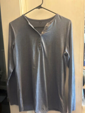 Long sleeved medium blue T-shirt with buttons